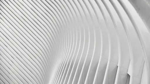 Abstract white curved architectural surface with parallel ridges creating wave-like pattern